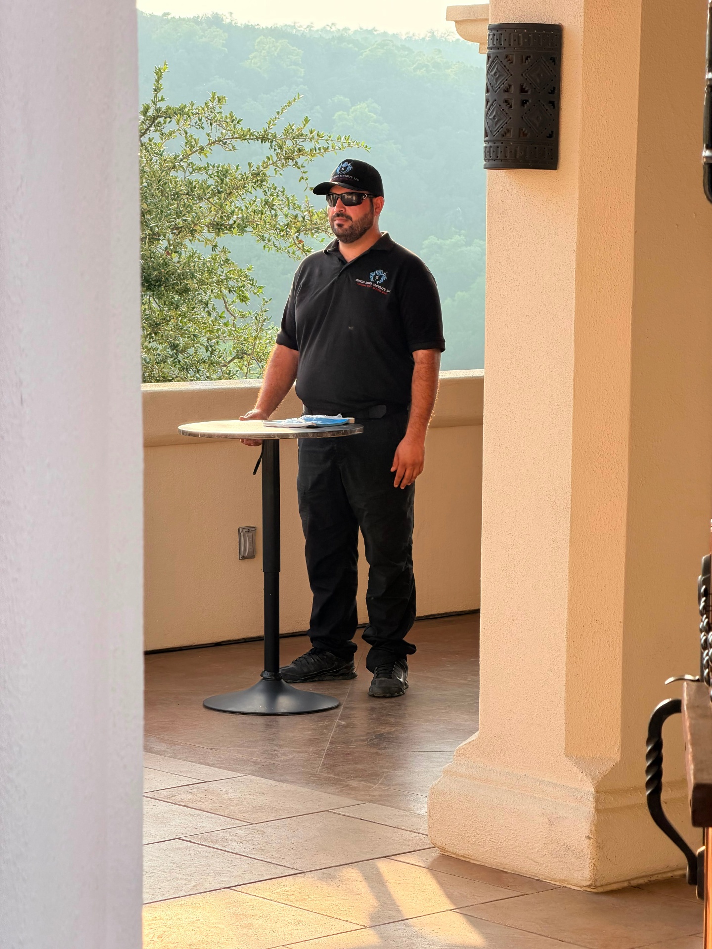 Shield Spire Security officer standing beside a cocktail table overlooking a premium private event venue in Cedar Park, Texas.